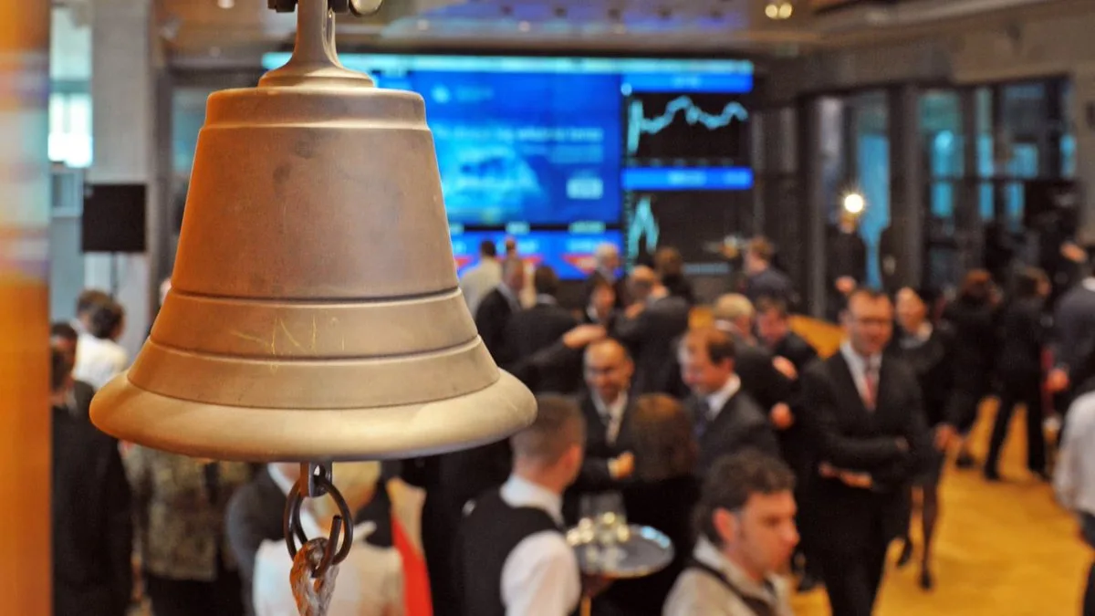 the opening bell above a crowded stock exchange floor